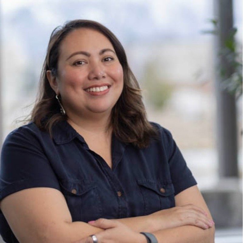 Maribel, smiling, in a navy shirt